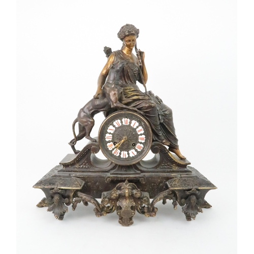 385 - A FRENCH PATINATED SPELTER MANTLE CLOCKmodelled as Diana holding a bow with a dog at her side, the d... 