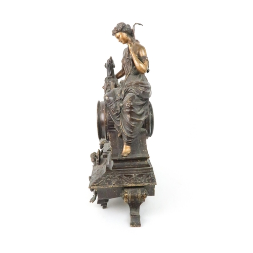 385 - A FRENCH PATINATED SPELTER MANTLE CLOCKmodelled as Diana holding a bow with a dog at her side, the d... 