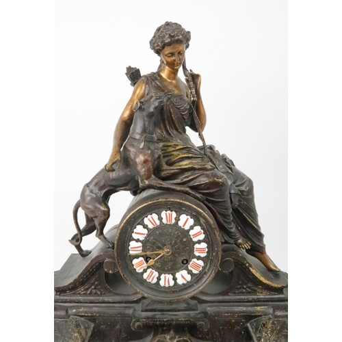 385 - A FRENCH PATINATED SPELTER MANTLE CLOCKmodelled as Diana holding a bow with a dog at her side, the d... 