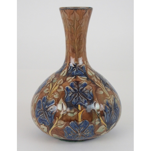 391 - A DELLA ROBBIA POTTERY VASEof bottle shape, with relief decoration of blue flowers on a brown ground... 