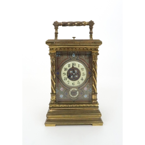 393 - A FRENCH BRASS AND GLASS REPEATER CARRIAGE CLOCKwith acanthus topped barley twist supports, the silv... 