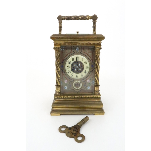 393 - A FRENCH BRASS AND GLASS REPEATER CARRIAGE CLOCKwith acanthus topped barley twist supports, the silv... 