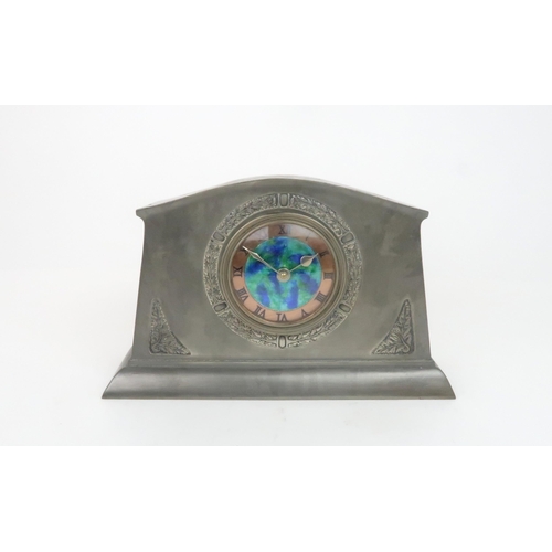 394 - A LIBERTY & CO ENGLISH PEWTER CLOCKthe dial with central mottled blue and green enamel with a co... 