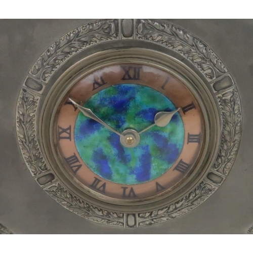 394 - A LIBERTY & CO ENGLISH PEWTER CLOCKthe dial with central mottled blue and green enamel with a co... 