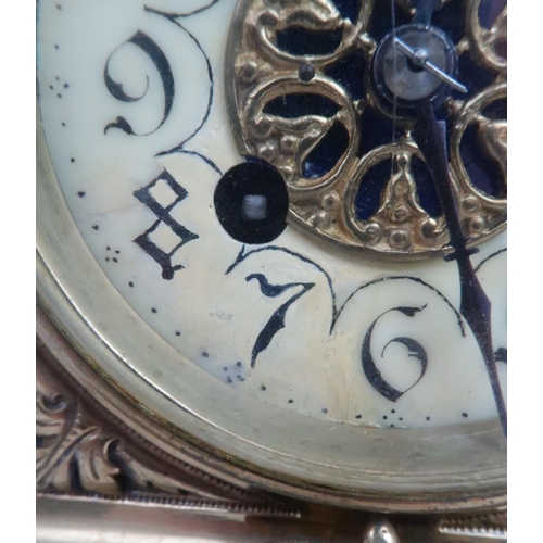 398 - A FRENCH BRASS MANTLE CLOCKwith cherub finial and central mask above the dial, the dial with arabic ... 