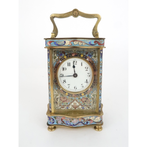 402 - AN EARLY 20TH CENTURY FRENCH BRASS AND CHAMPLEVE ENAMEL CARRIAGE CLOCKthe white dial with arabic num... 