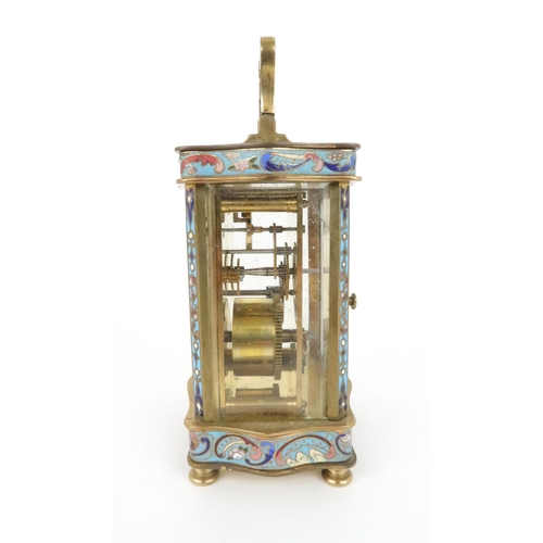 402 - AN EARLY 20TH CENTURY FRENCH BRASS AND CHAMPLEVE ENAMEL CARRIAGE CLOCKthe white dial with arabic num... 