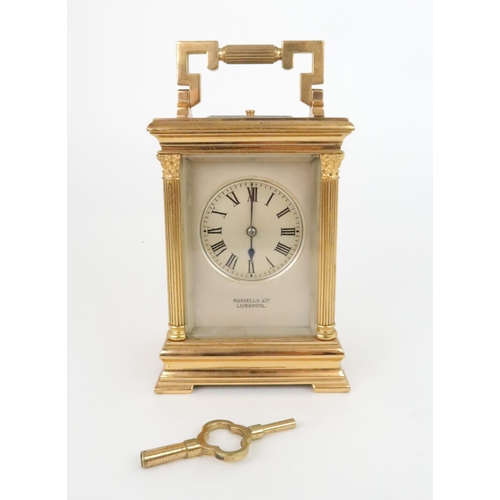 403 - A FRENCH GILT METAL REPEATING CARRIAGE CLOCKwith silvered face and dial with roman numerals, platfor... 