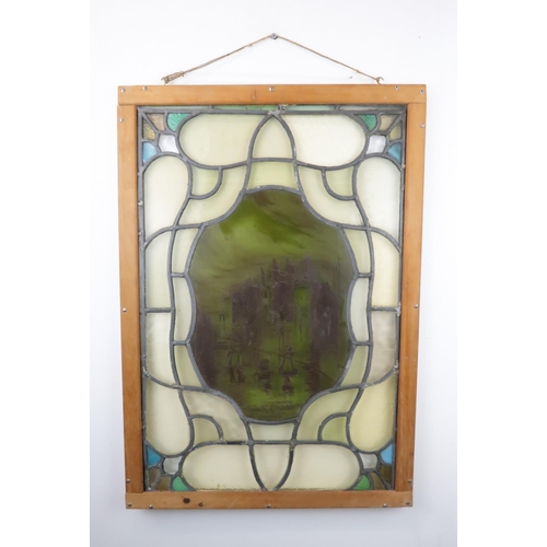 427 - A STAINED AND LEADED GLASS PANELdepicting Gorbals Chapel, Glasgow, in wooden frame, 77cm x 54cm... 