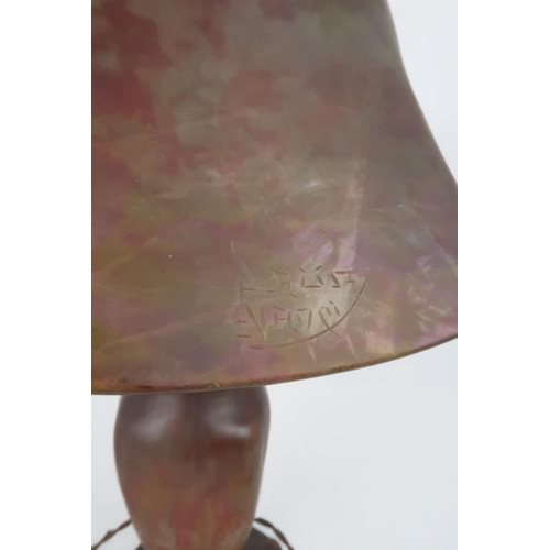 432 - A DAUM NANCY MOTTLED GLASS TABLE LAMPin mottled shades of green and pink, with hammered metal mounts... 