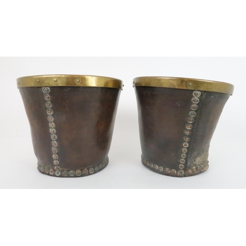 551 - A PAIR OF VICTORIAN LEATHER AND BRASS BOUND BUCKETS with stud work, 23cm high x 26cm wide... 