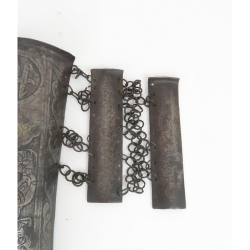 552 - A MIDDLE-EASTERN IRON ARM GUARD BAZU BAND decorated with figures, with wrist guard, 32cm long... 