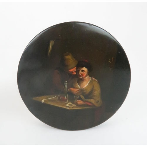 553 - A PAPIER MACHE CIRCULAR SNUFF BOX the lid decorated with a courting couple in a tavern, 10cm diamete... 