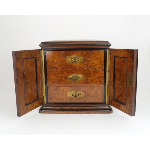 554 - A VICTORIAN BURR WALNUT THREE DRAWER COLLECTORS/TABLE CABINET with hinged doors and brass inset draw... 