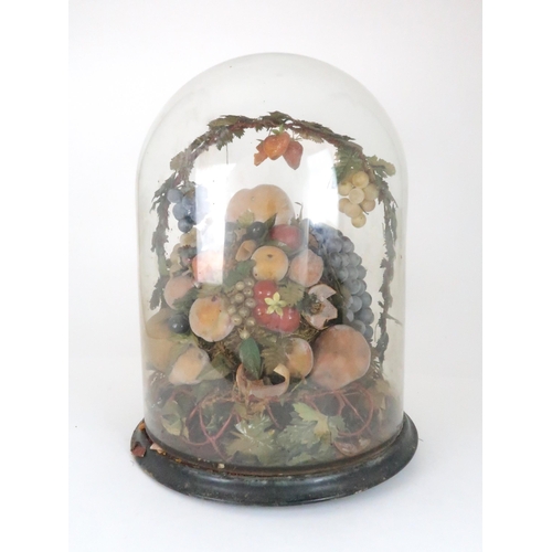 562 - A VICTORIAN WAX DISPLAY OF FRUITon circular base with domed glass case, (af), 50cm high... 