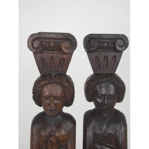 567 - A PAIR OF CARVED OAK FIGURAL PANELSdepicting a male and female, the male with arms crossed, 51cm hig... 