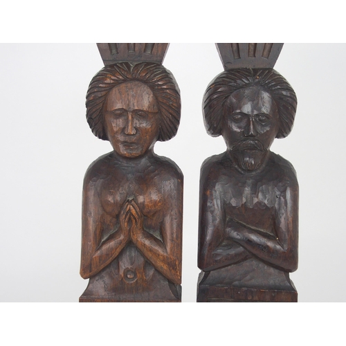 567 - A PAIR OF CARVED OAK FIGURAL PANELSdepicting a male and female, the male with arms crossed, 51cm hig... 