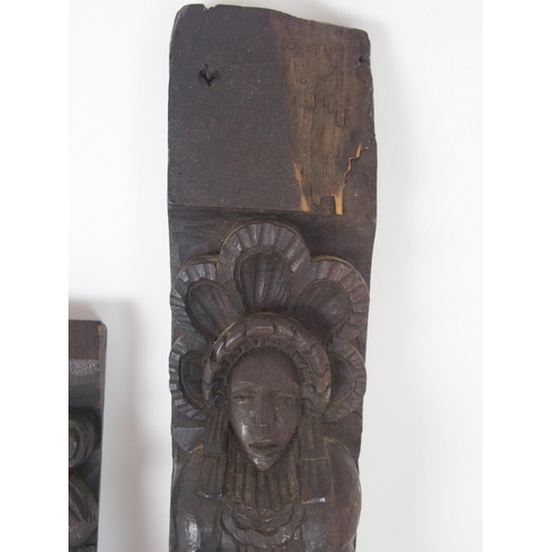 568 - A CARVED OAK PANEL OF A MANand another of a lady, 53cm and 64cm high (2)