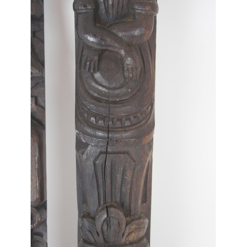 568 - A CARVED OAK PANEL OF A MANand another of a lady, 53cm and 64cm high (2)