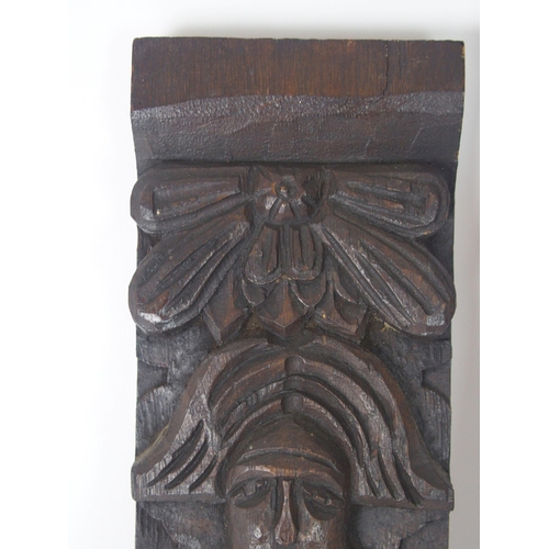 568 - A CARVED OAK PANEL OF A MANand another of a lady, 53cm and 64cm high (2)