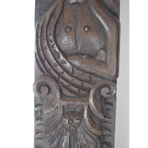 568 - A CARVED OAK PANEL OF A MANand another of a lady, 53cm and 64cm high (2)