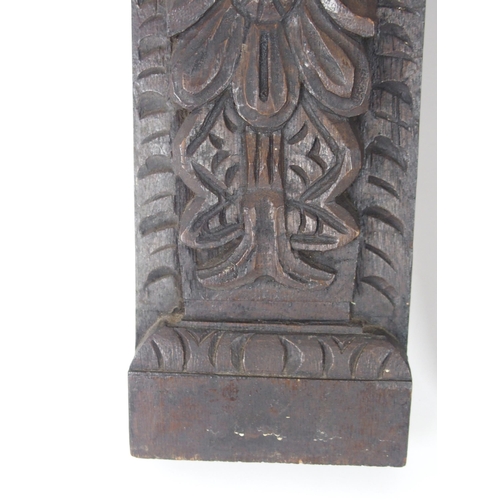 568 - A CARVED OAK PANEL OF A MANand another of a lady, 53cm and 64cm high (2)