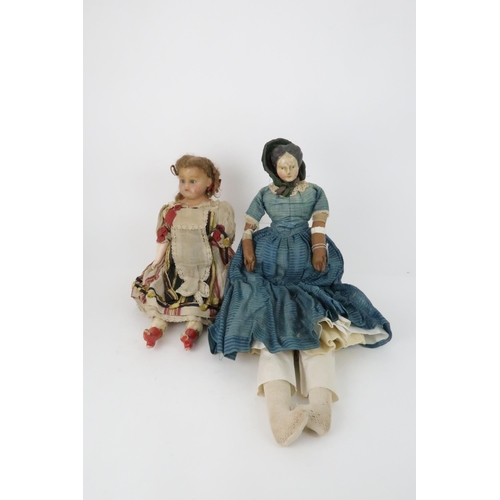 574 - AN EARLY PAPIER MACHE SHOULDER HEAD DOLLwith painted features, with dress and bonnet, 69cm long and ... 