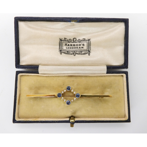 701 - A 15CT GOLD SAPPHIRE AND PEARL BAR BROOCH in original Harrod's box, length 6cm, sapphires approx 3mm... 