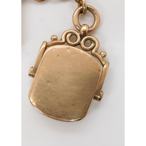 703 - A 9CT GOLD FOB CHAIN with an attached carnelian swivel fob seal, length to include both lobster claw... 