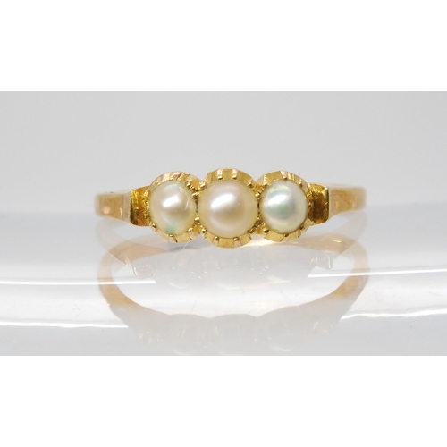 706 - A BRIGHT YELLOW METAL THREE HALF PEARL RING the pearls in cut back settings. finger size M, weight 2... 