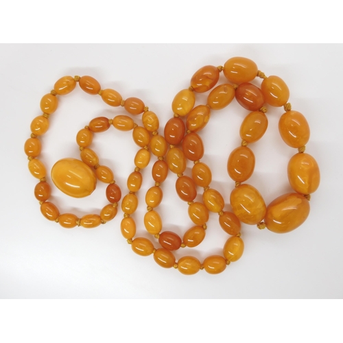 707 - A STRING OF BUTTERSCOTCH COLOUR AMBER BEADS strung length 97cm, weight 74.6gms (with one spare loose... 