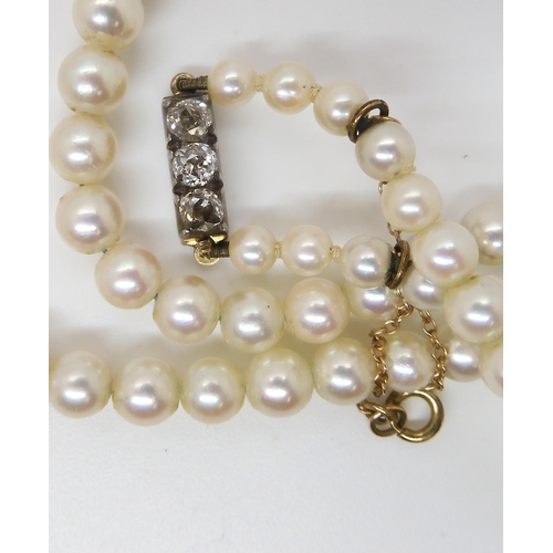 711 - A GOOD QUALITY STRING OF PEARLS WITH AN OLD CUT DIAMOND CLASP the three old cuts are estimated appro... 