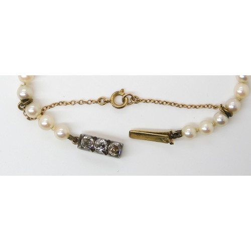 711 - A GOOD QUALITY STRING OF PEARLS WITH AN OLD CUT DIAMOND CLASP the three old cuts are estimated appro... 