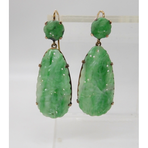 713 - A PAIR OF CHINESE GREEN HARDSTONE EARRINGS mounted in yellow metal with the hardstones, pierced and ... 