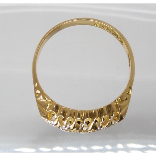 721 - AN 18CT GOLD FIVE STONE DIAMOND RING in classic scroll mount, with full Chester hallmarks for 1904, ... 