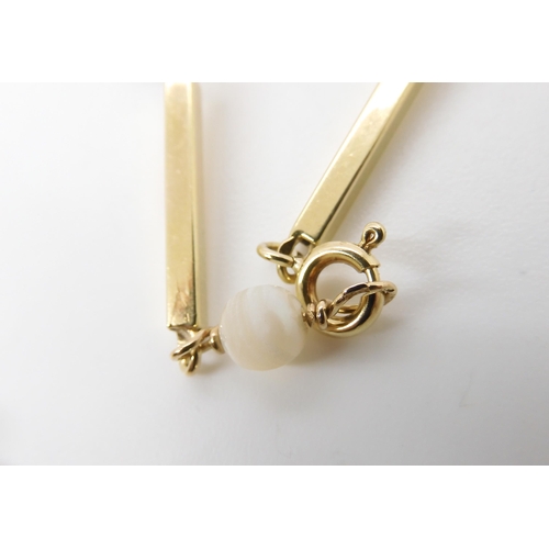 790 - A BRIGHT YELLOW METAL BATON LINK NECKLACEstrung with pearls throughout its length. the clasp and a l... 