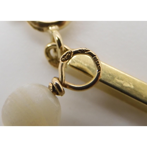 790 - A BRIGHT YELLOW METAL BATON LINK NECKLACEstrung with pearls throughout its length. the clasp and a l... 