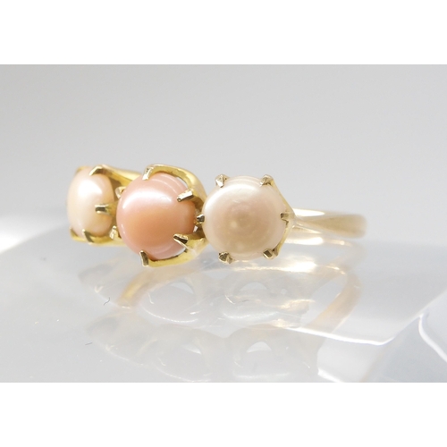 794 - A SCOTTISH RIVER PEARL RINGthe three button pearls in shades of pink are set into a classic crown mo... 