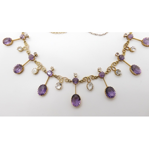 796 - A YELLOW METAL AMETHYST AND ROCK CRYSTAL FRINGE NECKLACEwith millgrain knife edge drops, crown mount... 