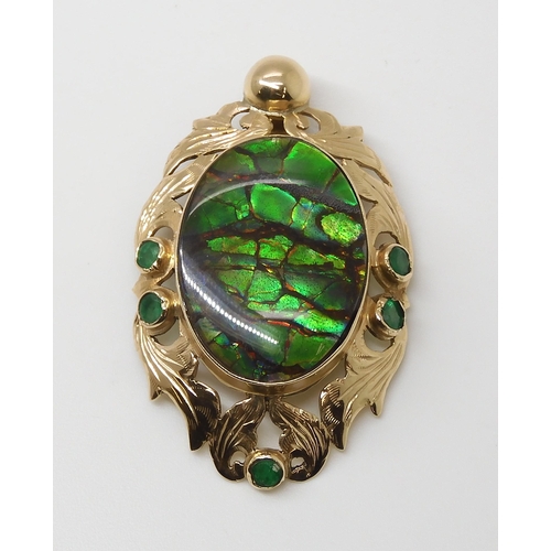 799 - A YELLOW METAL AMMOLITE AND EMERALD PENDANTsigned by goldsmith C. Noir, inscribed 14k. Set with an a... 