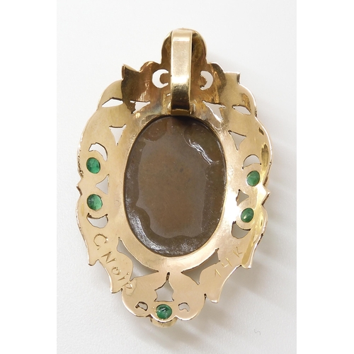 799 - A YELLOW METAL AMMOLITE AND EMERALD PENDANTsigned by goldsmith C. Noir, inscribed 14k. Set with an a... 