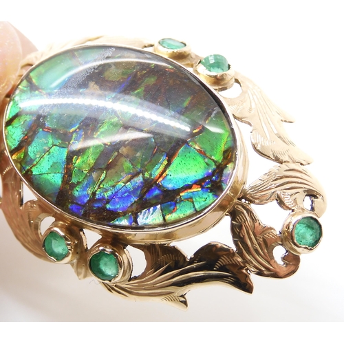 799 - A YELLOW METAL AMMOLITE AND EMERALD PENDANTsigned by goldsmith C. Noir, inscribed 14k. Set with an a... 