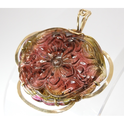 811 - A WATERMELON TOURMALINE PENDANTcarved on both sides as a flower, with 14k gold pendant clip mount, s... 