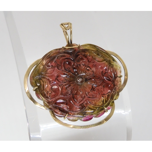 811 - A WATERMELON TOURMALINE PENDANTcarved on both sides as a flower, with 14k gold pendant clip mount, s... 