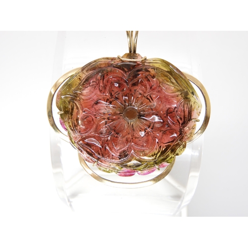 811 - A WATERMELON TOURMALINE PENDANTcarved on both sides as a flower, with 14k gold pendant clip mount, s... 