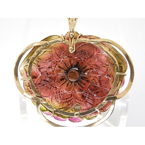 811 - A WATERMELON TOURMALINE PENDANTcarved on both sides as a flower, with 14k gold pendant clip mount, s... 