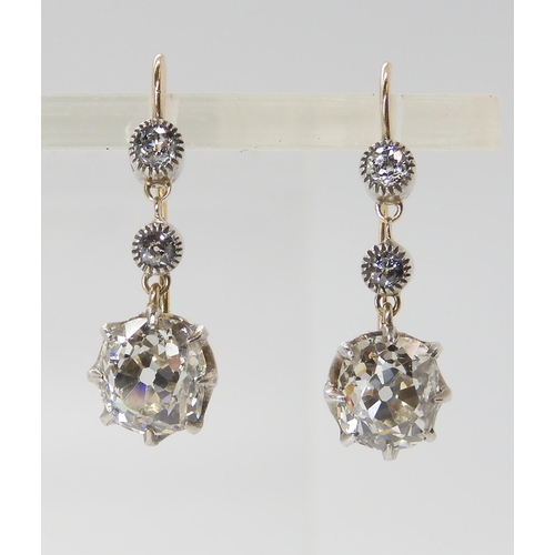 815 - A PAIR OF CUSHION CUT DIAMOND DROP EARRINGSmounted in yellow and white gold classic crown settings, ... 