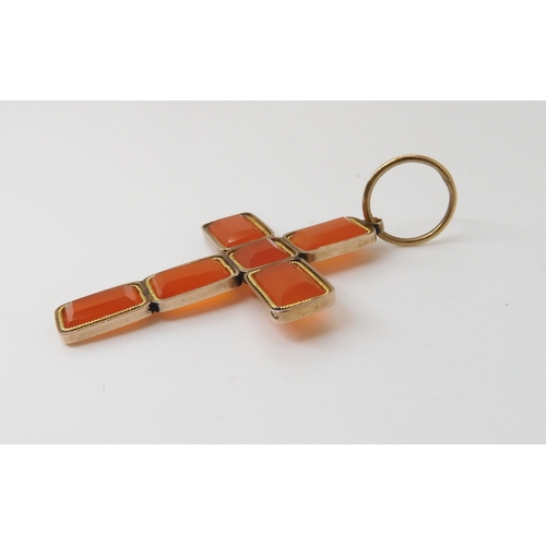 820 - A CARNELIAN CROSSmade from separate facet cut carnelians in vibrant orange mounted in yellow metal. ... 