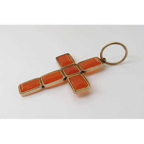 820 - A CARNELIAN CROSSmade from separate facet cut carnelians in vibrant orange mounted in yellow metal. ... 