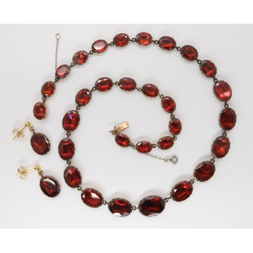 823 - AN ANTIQUE FOILED BACK GARNET PARUREcomprising of a necklace the garnets in  yellow metal cut b... 